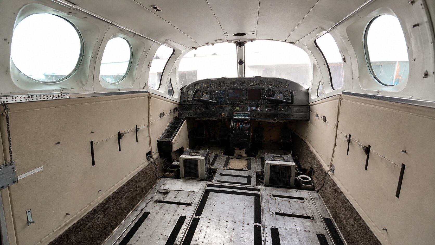 Aircraft cabin during interior disassembly by Paint My Plane